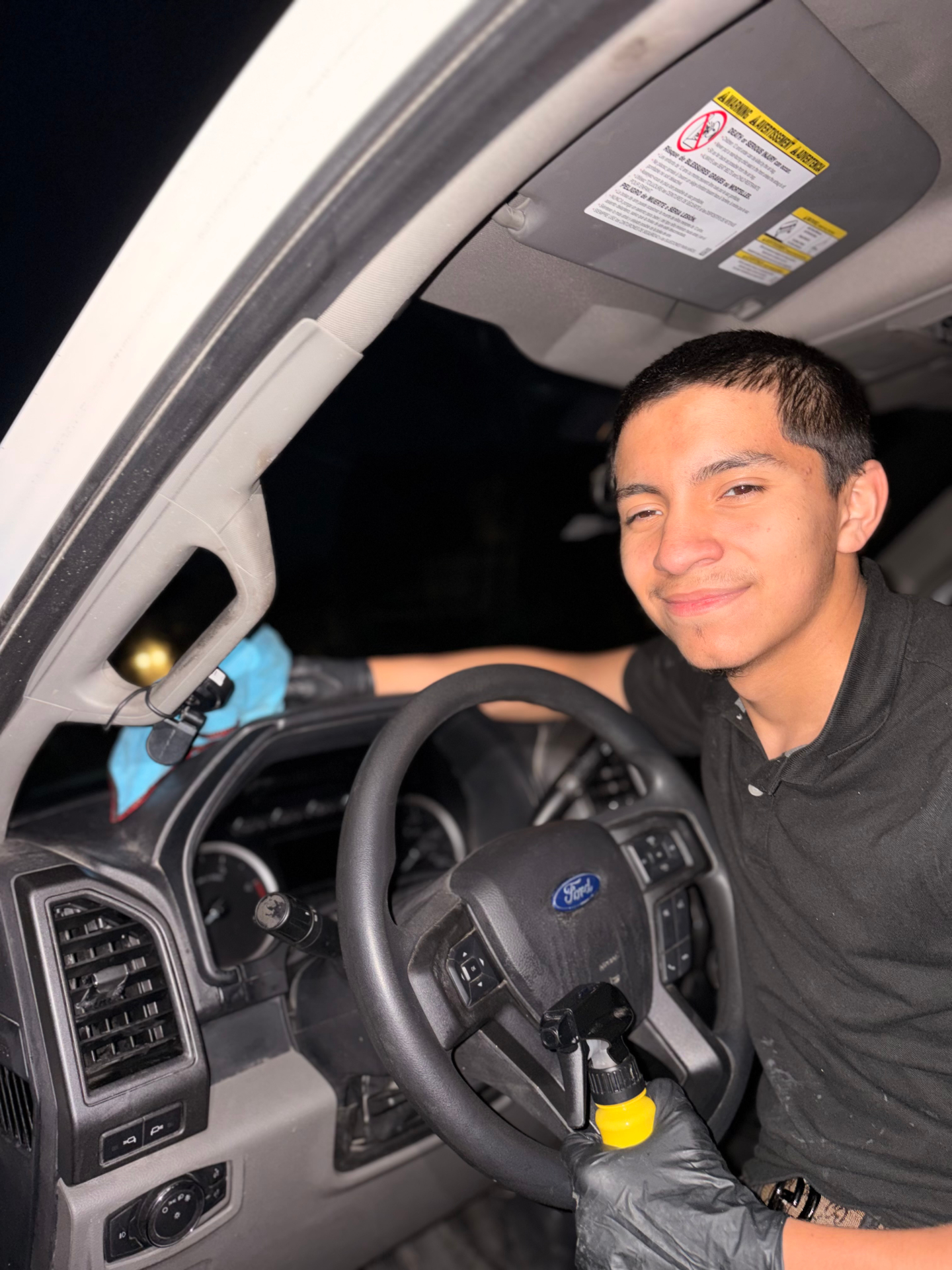 Alejandro, founder of ANG Auto Styles, detailing a Ford truck interior